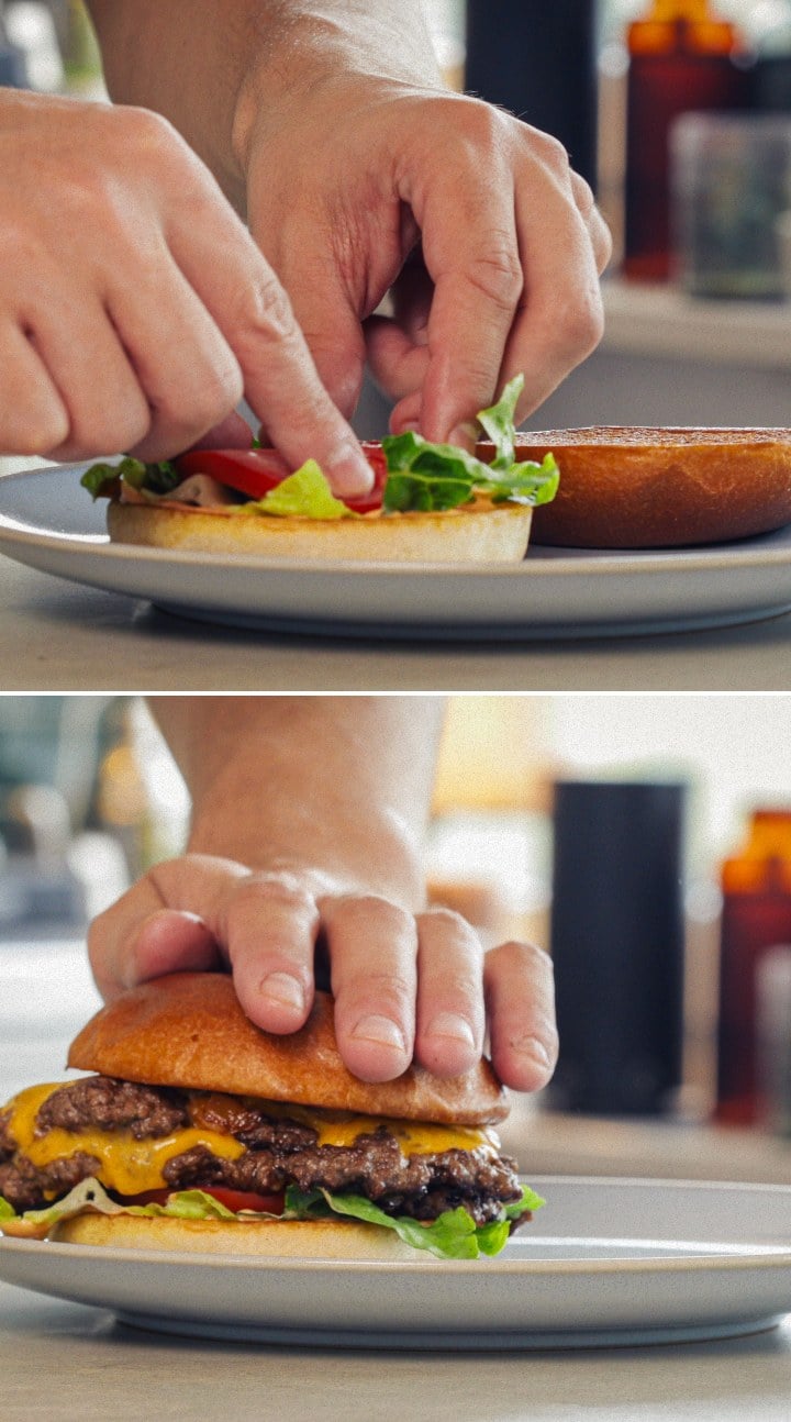 Assembling and serving a finished cannabis burger with melted cheddar, lettuce, tomato, and an infused bun