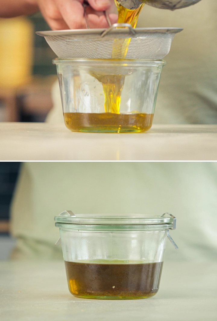Straining Cannabis-Infused Olive Oil Cannabis-infused olive oil being strained through a fine mesh sieve into a glass container.