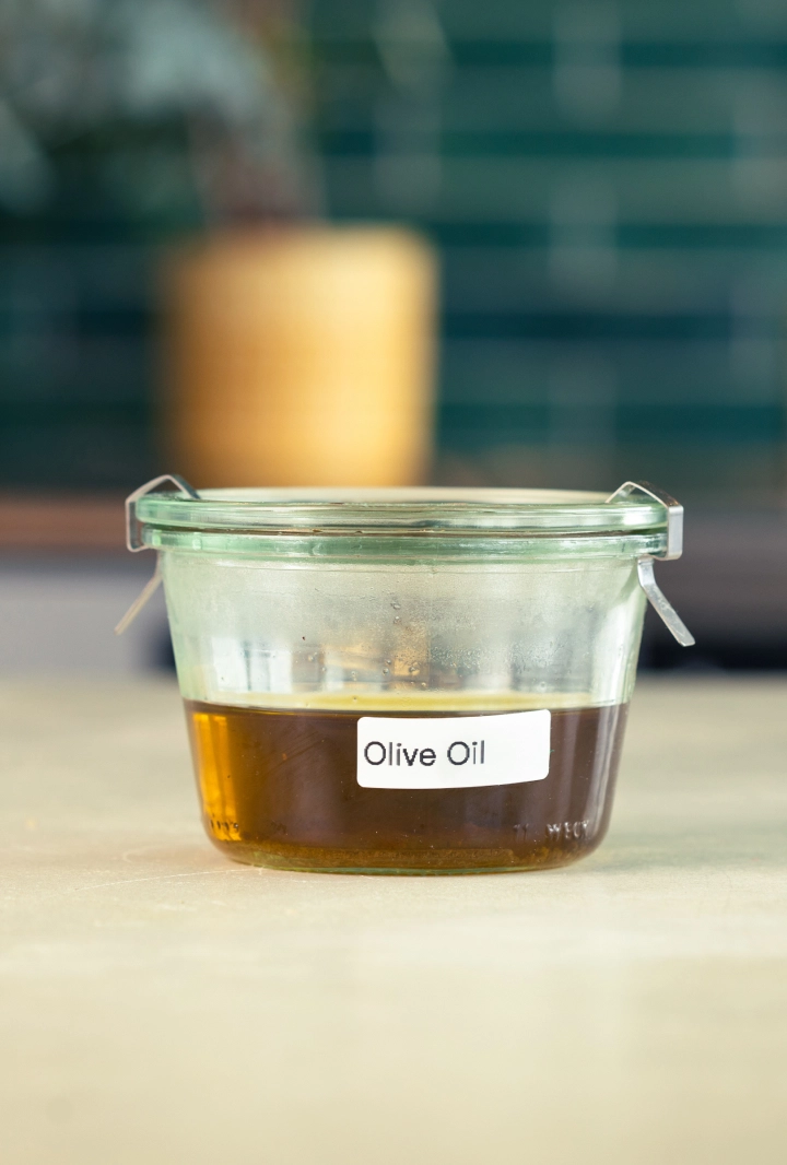 Storing Cannabis-Infused Olive Oil Glass container of cannabis-infused olive oil labeled and ready for storage.