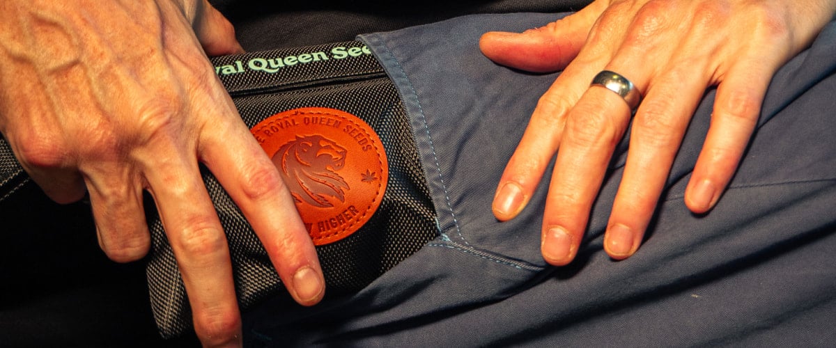 Smell-Proof Bag for Discreet Cannabis Storage Image of hands placing a smell-proof cannabis storage bag into a pocket.