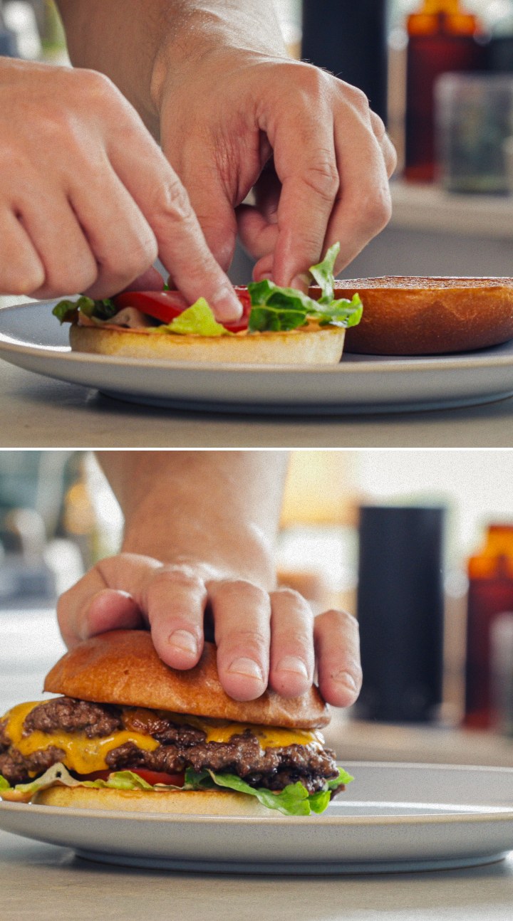 Assembling and serving a finished cannabis burger with melted cheddar, lettuce, tomato, and an infused bun